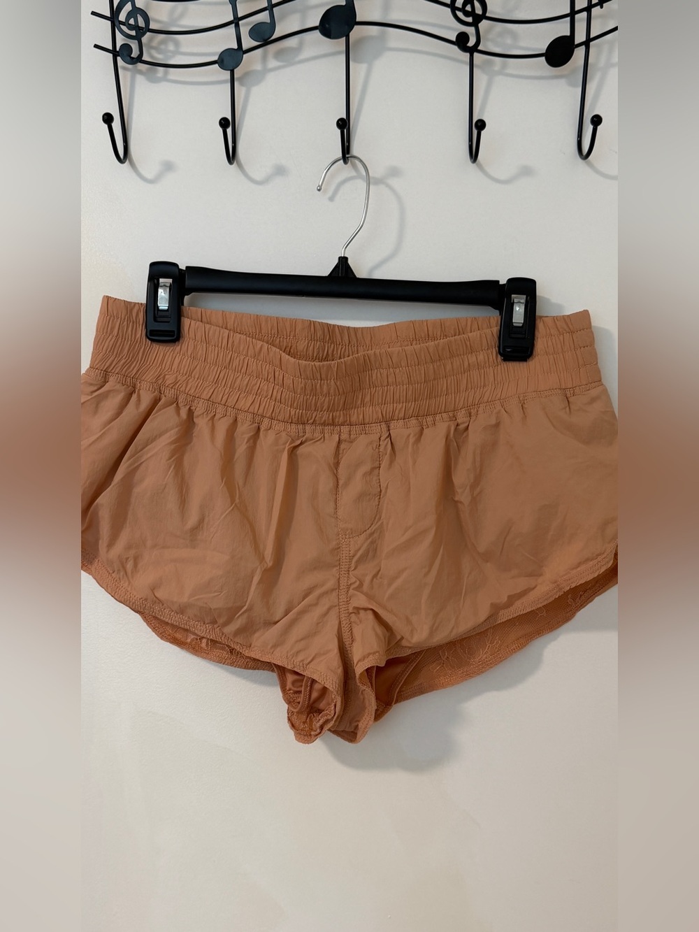 Free People Movement "The Way Home" shorts in a tan or light copper color.